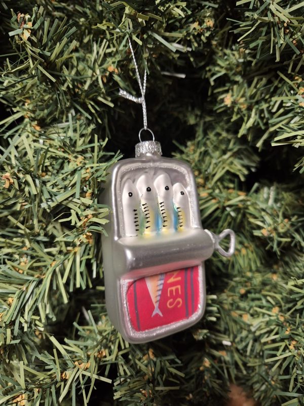 A Shines Lemon Juicer ornament hangs on a green Christmas tree branch.